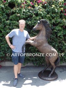 Thunderstorm sculpture of reared horse with forelegs off the ground and hind legs attached bronze base