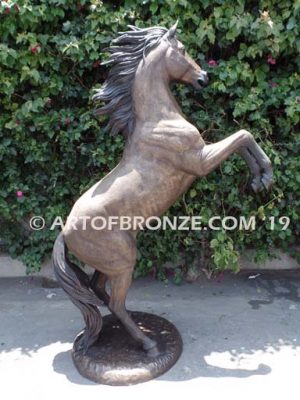 Thunderstorm sculpture of reared horse with forelegs off the ground and hind legs attached bronze base