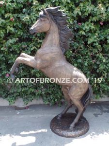 Thunderstorm sculpture of reared horse with forelegs off the ground and hind legs attached bronze base