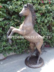 Thunderstorm sculpture of reared horse with forelegs off the ground and hind legs attached bronze base