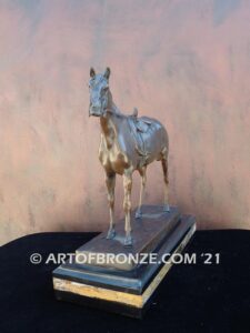 Saddled sculpture of standing horse with saddle and tack attached to base for indoor home or office