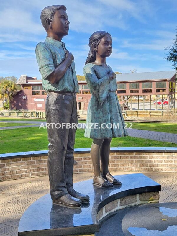 Pledge Allegiance wonderful outdoor bronze sculpture featuring two young kids with right hand on their hearts