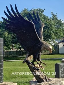 Southern Lyon County All Veterans Eagle war Memorial outdoor monumental statue of an eagle landing atop stone pillar