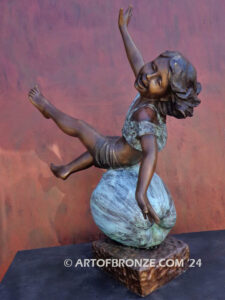 Apple of My Eye fantasy bronze statue of girl playing atop apple