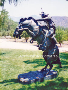 The Bronco Buster bronze sculpture after Frederic Remington featuring cowboy on horse