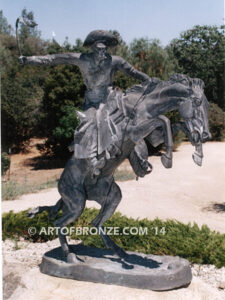 The Bronco Buster bronze sculpture after Frederic Remington featuring cowboy on horse