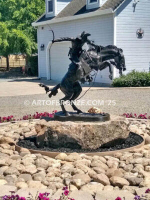 The Bronco Buster bronze sculpture after Frederic Remington featuring cowboy on horse