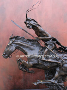 The Cheyenne bronze statue after Frederic Remington featuring warrior on galloping horse