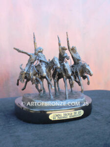 Coming Thru the Rye bronze sculpture after Frederic Remington featuring four horseman on galloping horses