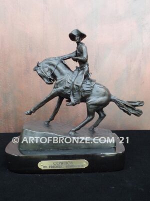 The Cowboy bronze sculpture after Frederic Remington featuring cowboy on horse