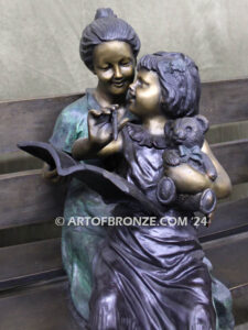 Mom Knows Best Bronze sculpture of little girl sitting on moms lap being read a book