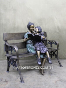 Mom Knows Best Bronze sculpture of little girl sitting on moms lap being read a book