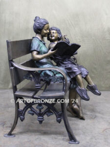 Mom Knows Best Bronze sculpture of little girl sitting on moms lap being read a book