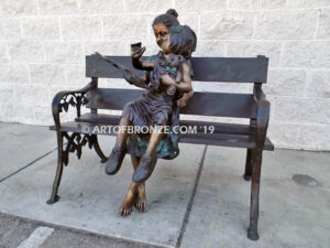 Mom Knows Best Bronze sculpture of little girl sitting on moms lap being read a book