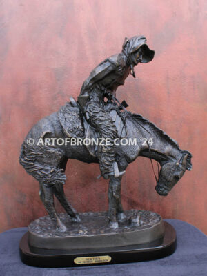 The Norther bronze statue after Frederic Remington featuring cowboy caught in forceful winds atop his horse