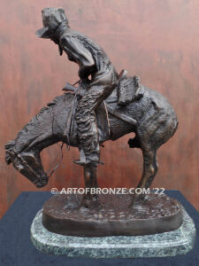 The Norther bronze statue after Frederic Remington featuring cowboy caught in forceful winds atop his horse