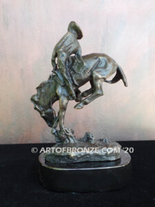 Outlaw bronze statue cowboy on bucking horse after Frederic Remington