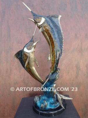 Parlay bronze sculpture of two marlins leaping upward above ocean waves on marble base