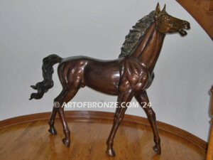 Prancing Delight bronze sculpture of running foal with flowing mane and tail with strong muscle details