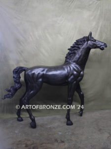 Prancing Delight bronze sculpture of running foal with flowing mane and tail with strong muscle details