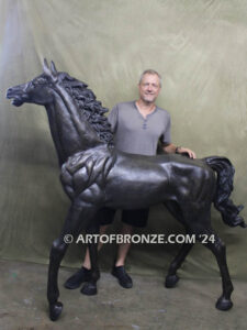 Prancing Delight bronze sculpture of running foal with flowing mane and tail with strong muscle details