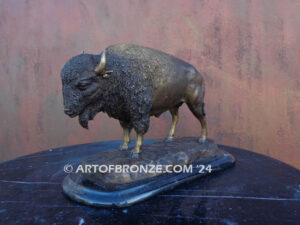 Pride of the Prairie bison bronze sculpture standing on rocky base with large horns and rich texturing