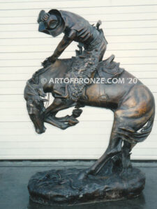 Rattlesnake bronze statue cowboy on bucking horse after Frederic Remington