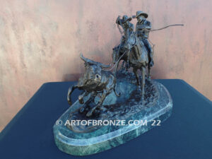 Round Up rodeo bronze sculpture of cowboys on horseback catching a steer