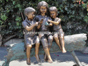 Special Touch bronze sculpture of three kids sitting on log with a injured baby bird in their hands