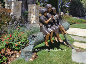 Special Touch bronze sculpture of three kids sitting on log with a injured baby bird in their hands