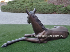 Spring Blessing bronze sculpture of resting foal, filly, colt and yearling horse for ranch or equestrian center