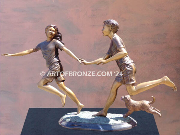 Springtime bronze statue of two young kids running together holding hands indoor artwork