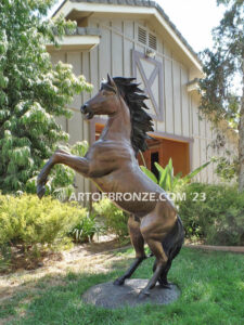 Thunderstorm sculpture of reared horse with forelegs off the ground and hind legs attached bronze base