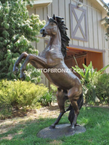 Thunderstorm sculpture of reared horse with forelegs off the ground and hind legs attached bronze base