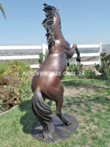 Thunderstorm sculpture of reared horse with forelegs off the ground and hind legs attached bronze base