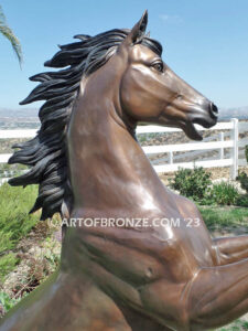 Thunderstorm sculpture of reared horse with forelegs off the ground and hind legs attached bronze base