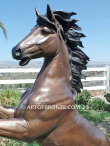 Thunderstorm sculpture of reared horse with forelegs off the ground and hind legs attached bronze base