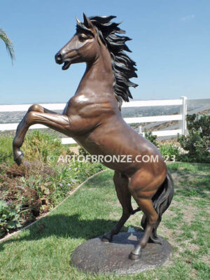 Thunderstorm sculpture of reared horse with forelegs off the ground and hind legs attached bronze base