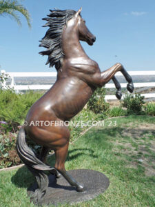 Thunderstorm sculpture of reared horse with forelegs off the ground and hind legs attached bronze base