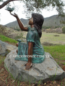 Wings of Joy bronze sculpture of sitting girl in dress with bronzes butterflies