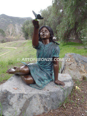 Wings of Joy bronze sculpture of sitting girl in dress with bronzes butterflies