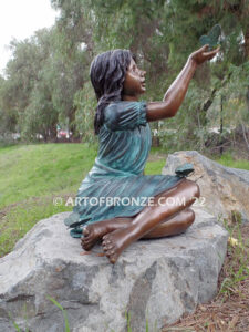 Wings of Joy bronze sculpture of sitting girl in dress with bronzes butterflies