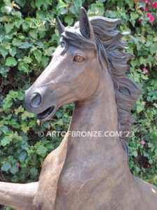 Thunderstorm statue of reared horse with forelegs off the ground and hind legs attached bronze base