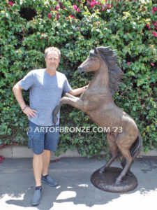 Thunderstorm statue of reared horse with forelegs off the ground and hind legs attached bronze base