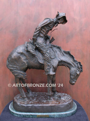 The Norther bronze statue after Frederic Remington featuring cowboy caught in forceful winds atop his horse