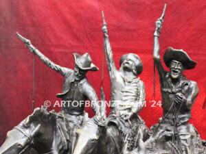 Coming Thru the Rye bronze statue after Frederic Remington featuring four horseman on galloping horses