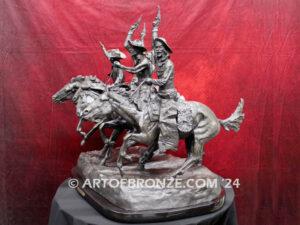 Coming Thru the Rye bronze statue after Frederic Remington featuring four horseman on galloping horses