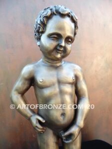 Manneken Pis 17th century bronze sculpture of naked little boy peeing into fountain