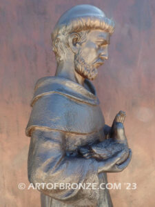 Saint Francis holding dove and giving blessing bronze statue