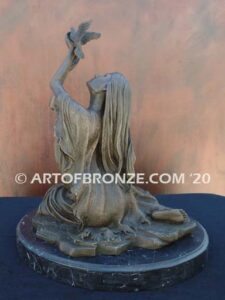 Spirit of the Sky bronze statue of seated Native American Indian woman holding bird